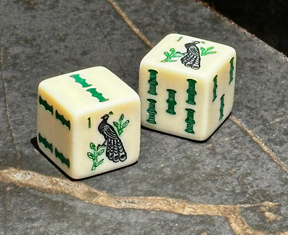 The Prestigious Peacock - one pair of standard size 19mm ivory dice with peacock and bam designs